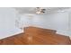 Bright living room with hardwood floors, ceiling fan, and a staircase leading to the upper level at 8147 Shadow Oak Dr, North Charleston, SC 29406