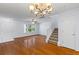 Bright living room with hardwood floors, ceiling fan, and a staircase leading to the upper level at 8147 Shadow Oak Dr, North Charleston, SC 29406