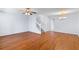 Bright living room with hardwood floors, ceiling fan, and a staircase leading to the upper level at 8147 Shadow Oak Dr, North Charleston, SC 29406