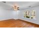 Bright living room with hardwood floors, ceiling fan, and a staircase leading to the upper level at 8147 Shadow Oak Dr, North Charleston, SC 29406