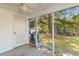 Covered and screened-in porch with access to a white door, and a view of trees at 8147 Shadow Oak Dr, North Charleston, SC 29406
