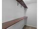 Walk-in closet with a built-in shelf on the wall and neutral colored carpeting at 8147 Shadow Oak Dr, North Charleston, SC 29406