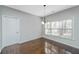 Cozy dining room with dark wood floors, light gray walls, and bright natural light from the window at 8502 Sentry Cir, North Charleston, SC 29420