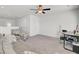 Bright bedroom featuring carpet floors, ceiling fan, sofa, and desk area at 9712 Transplanter Cir, Ladson, SC 29456