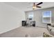 Bright bedroom featuring carpet floors, ceiling fan and desk area at 9712 Transplanter Cir, Ladson, SC 29456