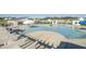 Inviting community pool with lounge chairs, umbrellas, and zero entry splash pad at 9712 Transplanter Cir, Ladson, SC 29456