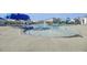 Resort-style community pool, zero-entry splashpad, and lounge area with umbrellas at 9712 Transplanter Cir, Ladson, SC 29456