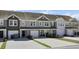 Attractive townhouse exteriors with two-car garages, manicured lawns and neutral-toned siding at 9712 Transplanter Cir, Ladson, SC 29456