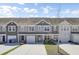 Charming townhouse with a two-car garage, complemented by a well-maintained front yard on a sunny day at 9712 Transplanter Cir, Ladson, SC 29456