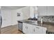 Kitchen island with granite countertops, stainless steel dishwasher, and open layout at 9712 Transplanter Cir, Ladson, SC 29456