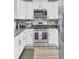 Modern kitchen with stainless steel appliances and white cabinetry at 9712 Transplanter Cir, Ladson, SC 29456