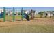 Community playground with swings, climbing wall, and green safety fence near neighborhood homes at 9712 Transplanter Cir, Ladson, SC 29456