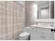 Cozy bathroom with patterned shower curtain, white vanity, and neutral color scheme at 1 Vendue Range # D, Charleston, SC 29401