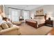 Bright bedroom with hardwood floors, plantation shutters, and neutral decor at 1 Vendue Range # D, Charleston, SC 29401