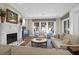 Inviting living room boasts a fireplace, plush seating, and a view of the water at 1 Vendue Range # D, Charleston, SC 29401