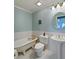 Bathroom featuring a clawfoot tub, pedestal sink, and vintage fixtures at 1039 Grand Concourse St, Charleston, SC 29412