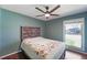 Bedroom featuring a bed with a decorative headboard, ceiling fan and a large window at 1039 Grand Concourse St, Charleston, SC 29412