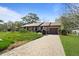 Attractive single story home with brick facade, paved drive, and established plantings at 1039 Grand Concourse St, Charleston, SC 29412