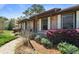 Inviting brick home entrance with window shutters and colorful blooming shrubbery at 1039 Grand Concourse St, Charleston, SC 29412