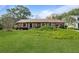 Charming one-story brick home featuring a well-manicured lawn and mature landscaping at 1039 Grand Concourse St, Charleston, SC 29412