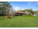 Charming brick home featuring a lush green lawn and mature landscaping at 1039 Grand Concourse St, Charleston, SC 29412