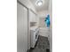 Laundry room featuring a washer and dryer, gray tiled floors, and storage cabinets at 1039 Grand Concourse St, Charleston, SC 29412
