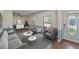 Bright living room showcasing neutral furniture, hardwood floors, and natural light through large windows at 1039 Grand Concourse St, Charleston, SC 29412