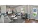 Bright living room showcasing neutral furniture, hardwood floors, and natural light through large windows at 1039 Grand Concourse St, Charleston, SC 29412