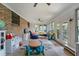 Sunroom featuring brick accent wall, tile flooring, and bright natural light at 1039 Grand Concourse St, Charleston, SC 29412