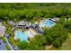 Aerial view of community pools and clubhouse surrounded by mature trees and landscaping at 1077 Ship Builder St, Charleston, SC 29492