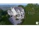 Stunning exterior elevation of a light two-story home featuring a large front-facing porch at 1077 Ship Builder St, Charleston, SC 29492