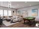 Spacious game room with comfortable seating, foosball table, and a billiard table at 1077 Ship Builder St, Charleston, SC 29492