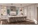 A modern kitchen with white cabinets, marble countertops, a large island, and barstool seating at 1077 Ship Builder St, Charleston, SC 29492
