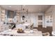 A spacious, open-concept kitchen features a large marble-top island and a dining area at 1077 Ship Builder St, Charleston, SC 29492