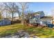 Exterior shot of home featuring an enclosed porch, open deck, and spacious backyard with a storage shed at 115 Laurel Ridge Rd, North Charleston, SC 29418