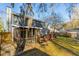 Back of home featuring a screened-in porch, deck, grill, and spacious yard, great for outdoor living at 115 Laurel Ridge Rd, North Charleston, SC 29418