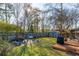 Serene backyard featuring a deck, large trees, and a storage shed with a fenced perimeter for privacy at 115 Laurel Ridge Rd, North Charleston, SC 29418