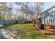 Spacious backyard features a shed, mature trees, swing set, and outdoor living space for relaxation and play at 115 Laurel Ridge Rd, North Charleston, SC 29418