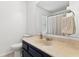 Clean bathroom with dark cabinets, light countertops, toilet, and framed mirror at 115 Laurel Ridge Rd, North Charleston, SC 29418