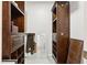 Walk-in closet featuring dark wood shelving units on a light tile floor at 115 Laurel Ridge Rd, North Charleston, SC 29418