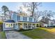 Charming two-story home with a welcoming front porch and well-manicured lawn at 115 Laurel Ridge Rd, North Charleston, SC 29418