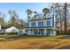 Inviting two-story house with a cozy front porch and lush green lawn at 115 Laurel Ridge Rd, North Charleston, SC 29418