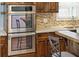 Modern double oven and decorative backsplash complement the breakfast bar in this updated kitchen at 115 Laurel Ridge Rd, North Charleston, SC 29418