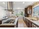 Modern kitchen features dark cabinets, stainless steel appliances, tile backsplash, and island with cooktop at 115 Laurel Ridge Rd, North Charleston, SC 29418