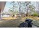 Large backyard with lush grass, mature trees, outdoor storage, a grill, and a paver patio at 117 Loblolly Ln, Summerville, SC 29483
