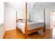 Bright bedroom featuring a four-poster bed, ceiling fan and hardwood floors at 117 Loblolly Ln, Summerville, SC 29483