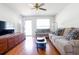 Inviting living room with a ceiling fan, cozy seating, TV, natural light, and rich wood floors at 117 Loblolly Ln, Summerville, SC 29483