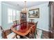 A lovely dining room featuring a dark wood dining table, chandelier, and stylish china cabinet at 1233 Bridgeport Dr, Mount Pleasant, SC 29466