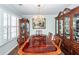 Formal dining room with elegant chandelier, a large wood table, and built-in china cabinets at 1233 Bridgeport Dr, Mount Pleasant, SC 29466
