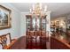 Dining area with a large table, chandelier, built-in hutch, and a peek into the living room at 1233 Bridgeport Dr, Mount Pleasant, SC 29466